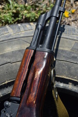 Fore-end, gas tube cover and barrel of Kalashnikov carbine, lies on tyre