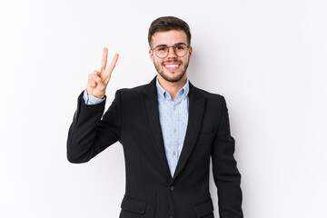 Young caucasian business man posing in a white background isolated Young caucasian business man showing victory sign and smiling broadly.