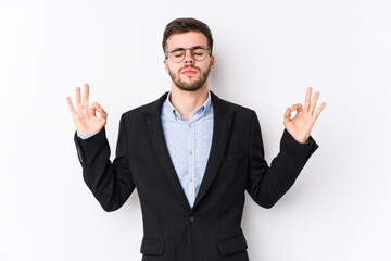 Young caucasian business man posing in a white background isolated Young caucasian business man relaxes after hard working day, she is performing yoga.