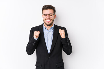 Young caucasian business man posing in a white background isolated Young caucasian business man raising fist, feeling happy and successful. Victory concept.
