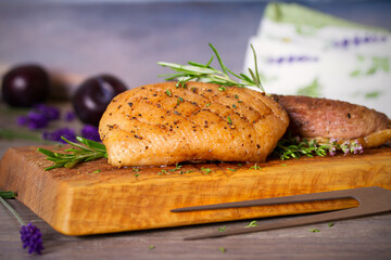 Roast duck breast fillet on serving board. horizontal image