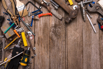 Scattered tools of the worker on wooden boards.