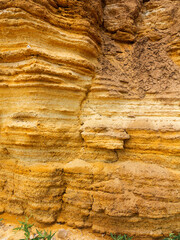 Desert landscape with multi-colored yellow, green and blue clay deposits of minerals in geological formations