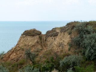 Mountain landslide disaster in sesmically dangerous area. Large cracks in earth, descent of large layers of earth blocking road. Mortal danger of damming people at foot of landslide slopes of mountain