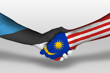 Handshake between malaysia and estonia flags painted on hands, illustration with clipping path.