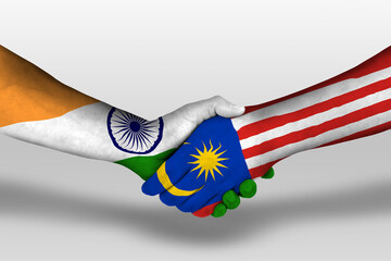 Handshake between malaysia and india flags painted on hands, illustration with clipping path.