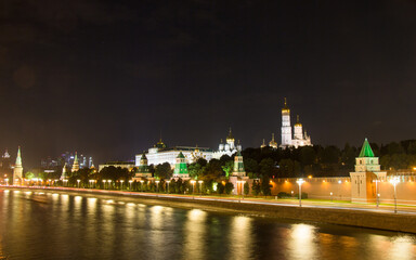 Fototapeta na wymiar The Moscow Kremlin in evening. Embankment, towers, temples, car traces