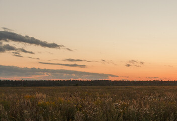 Sunset in Countryside, Moscow region, Russia. Blue clouds, orange sun strip.