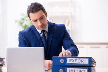 Young male logistics specialist working in the office