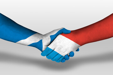 Handshake between luxembourg and scotland flags painted on hands, illustration with clipping path.