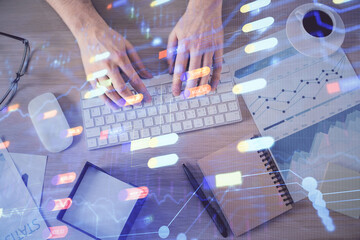 Double exposure of man's hands typing over computer keyboard and data theme hologram drawing. Top view. Technology concept.