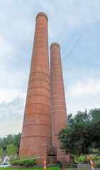 Two 135-foot smokestacks of the city’s former garbage incinerator, built in 1935 by Works Progress Administration.