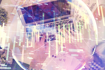 Double exposure of man's hands typing over computer keyboard and business theme hologram drawing....