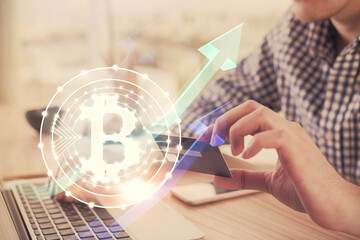 Double exposure of man hands holding a credit card and crypto business theme drawing. Digital...