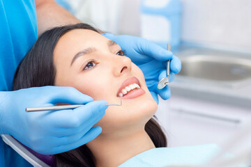 dentist examines the patients teeth at the dentist.