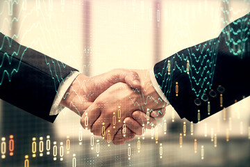 Double exposure of forex graph hologram and handshake of two men. Stock market concept.