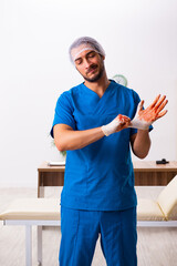Young male doctor surgeon in fatal negligence concept