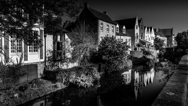 Brugge / Belgium - Sept. 18, 2018: Black and White Photo of Medieval houses reflecting in the waters of a canal in Bruges, Belgium