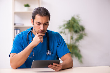 Young male doctor in telemedicine concept