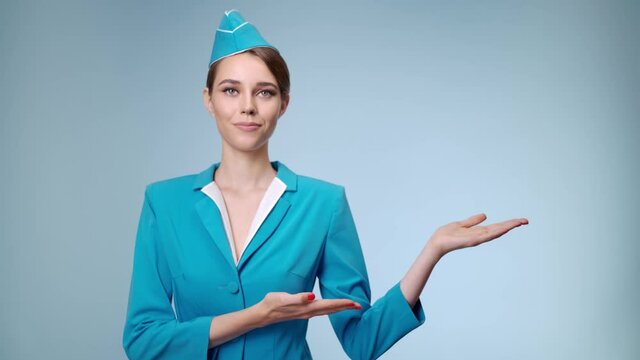 A friendly smiling stewardess makes an invitation.