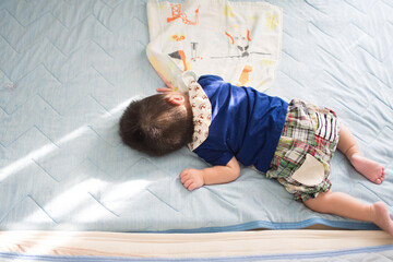 ベッドで寝ている日本人の赤ちゃん