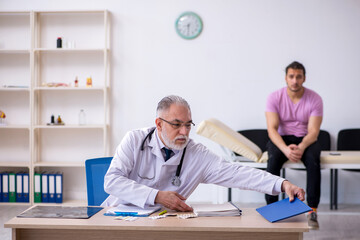 Young male patient visiting old male doctor