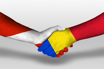 Handshake between romania and austria flags painted on hands, illustration with clipping path.