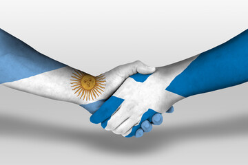 Handshake between scotland and argentina flags painted on hands, illustration with clipping path.