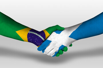 Handshake between scotland and brazil flags painted on hands, illustration with clipping path.