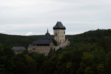 Fototapeta na wymiar Karlstein is a medieval royal castle, in the Czech forests and countryside during the day