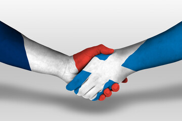 Handshake between scotland and france flags painted on hands, illustration with clipping path.