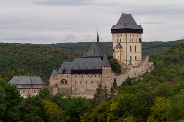  Karlstein is a medieval royal castle, in the Czech forests and countryside during the day
