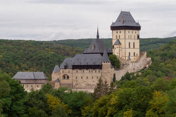 Fototapeta na wymiar Karlstein is a medieval royal castle, in the Czech forests and countryside during the day