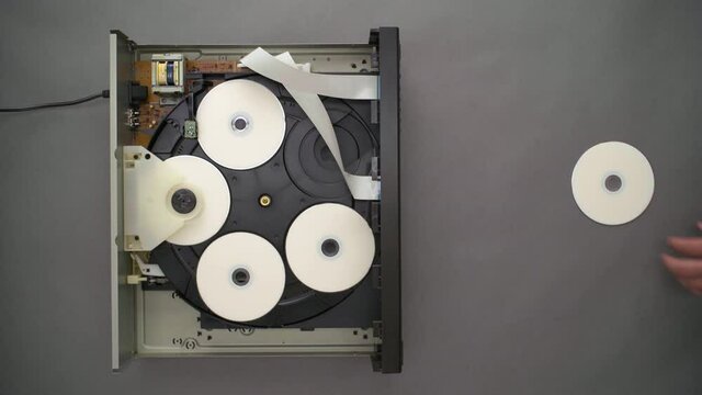 Top Down, Hand Inserts Blank CD into Open Top Five Disc Player