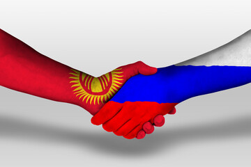 Handshake between russia and kyrgyzstan flags painted on hands, illustration with clipping path.