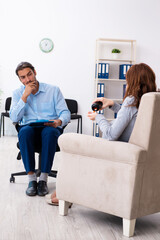 Pregnant woman visiting young male psychologist