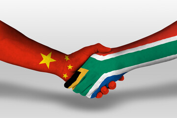 Handshake between south africa and china flags painted on hands, illustration with clipping path. © prehistorik