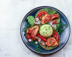 Baked chicken with rice on a round plate on a light gray background. Top view, flat lay