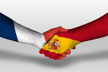Handshake between spain and france flags painted on hands, illustration with clipping path.