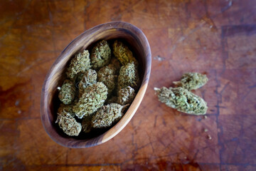 Close up of Cannabis in a wood bowl. wood background 