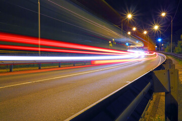 Fototapeta na wymiar Abstract background of car lights on the road. Night car traffic