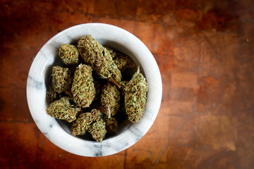 Close up of Cannabis in a bowl. wood background 