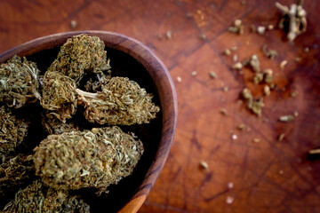 Close up of Cannabis in a wood bowl. wood background 