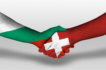 Handshake between switzerland and bulgaria flags painted on hands, illustration with clipping path.