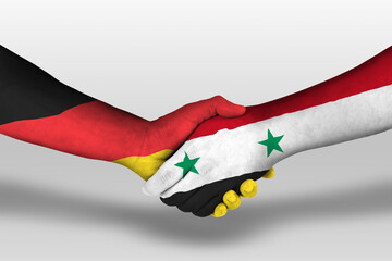 Handshake between syria and germany flags painted on hands, illustration with clipping path.