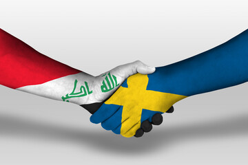 Handshake between sweden and iraq flags painted on hands, illustration with clipping path.