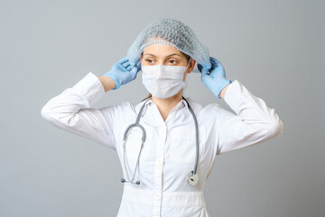 Female doctor or nurse wearing protective cap