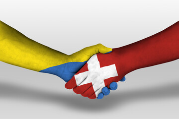 Handshake between switzerland and ukraine flags painted on hands, illustration with clipping path.