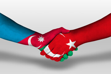 Handshake between turkey and azerbaijan flags painted on hands, illustration with clipping path.