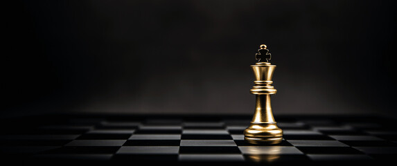 King golden chess standing on chess board concept of business strategic plan and professional...